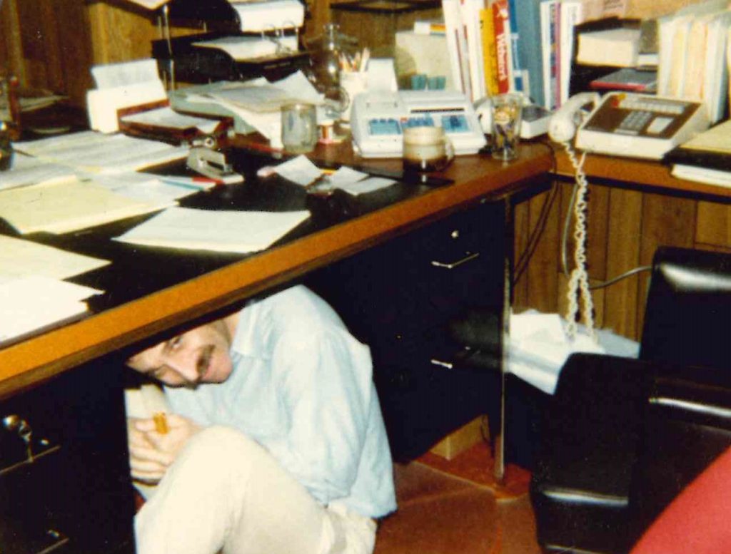Bobby Ginsberg hiding under his desk.