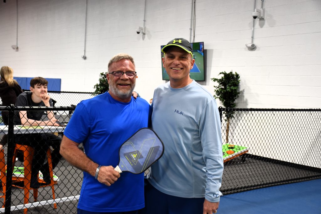 Two associates of Chesapeake playing pickleball.